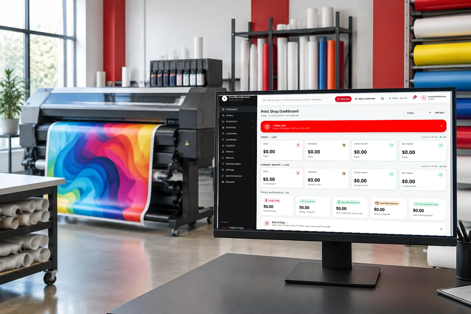 Large-format printer producing colourful vinyl in a bright print studio, with the actual PrintWorkMonitor dashboard shown on a desktop monitor